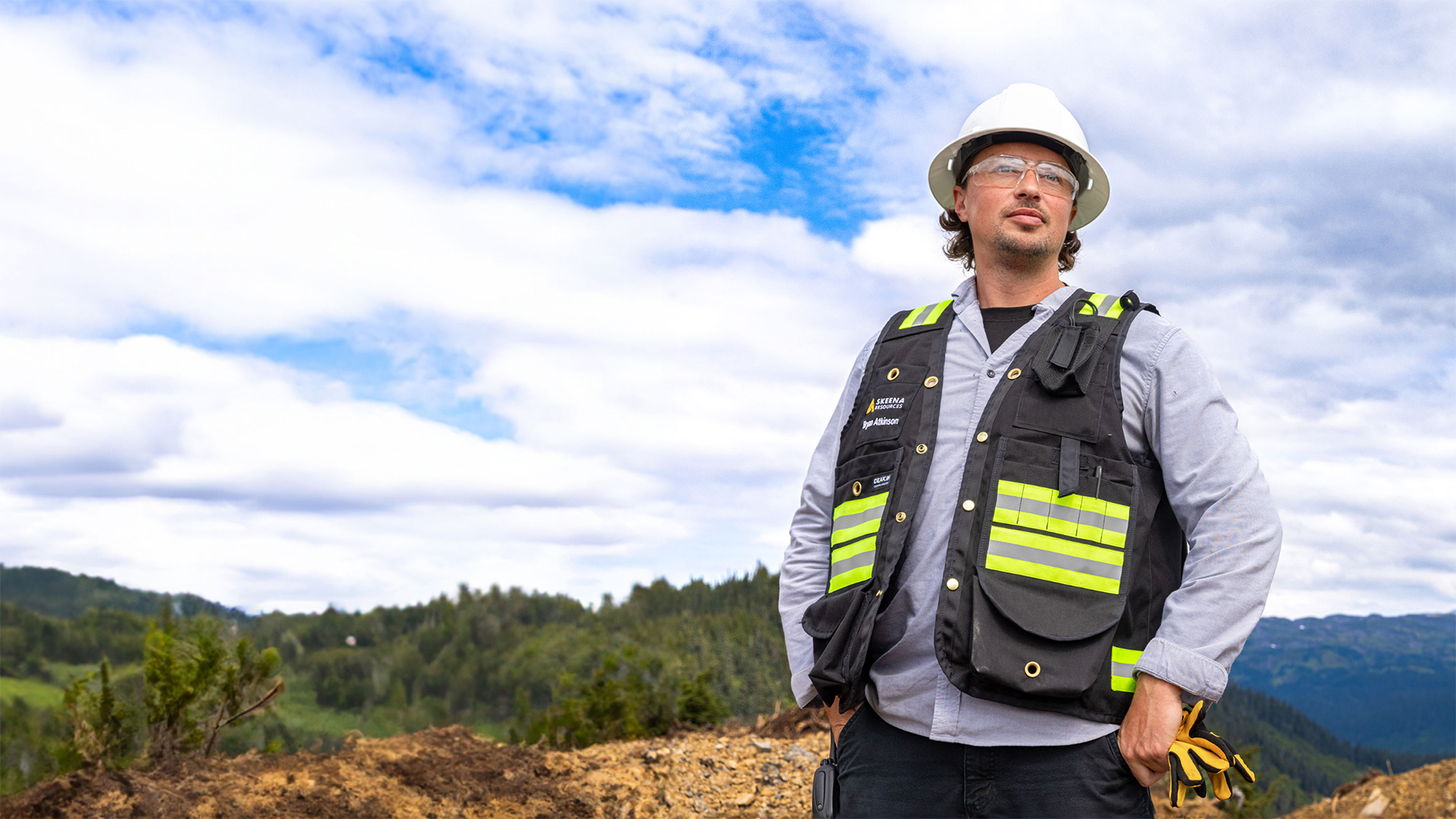 Worker Looking Out Over A Mountain