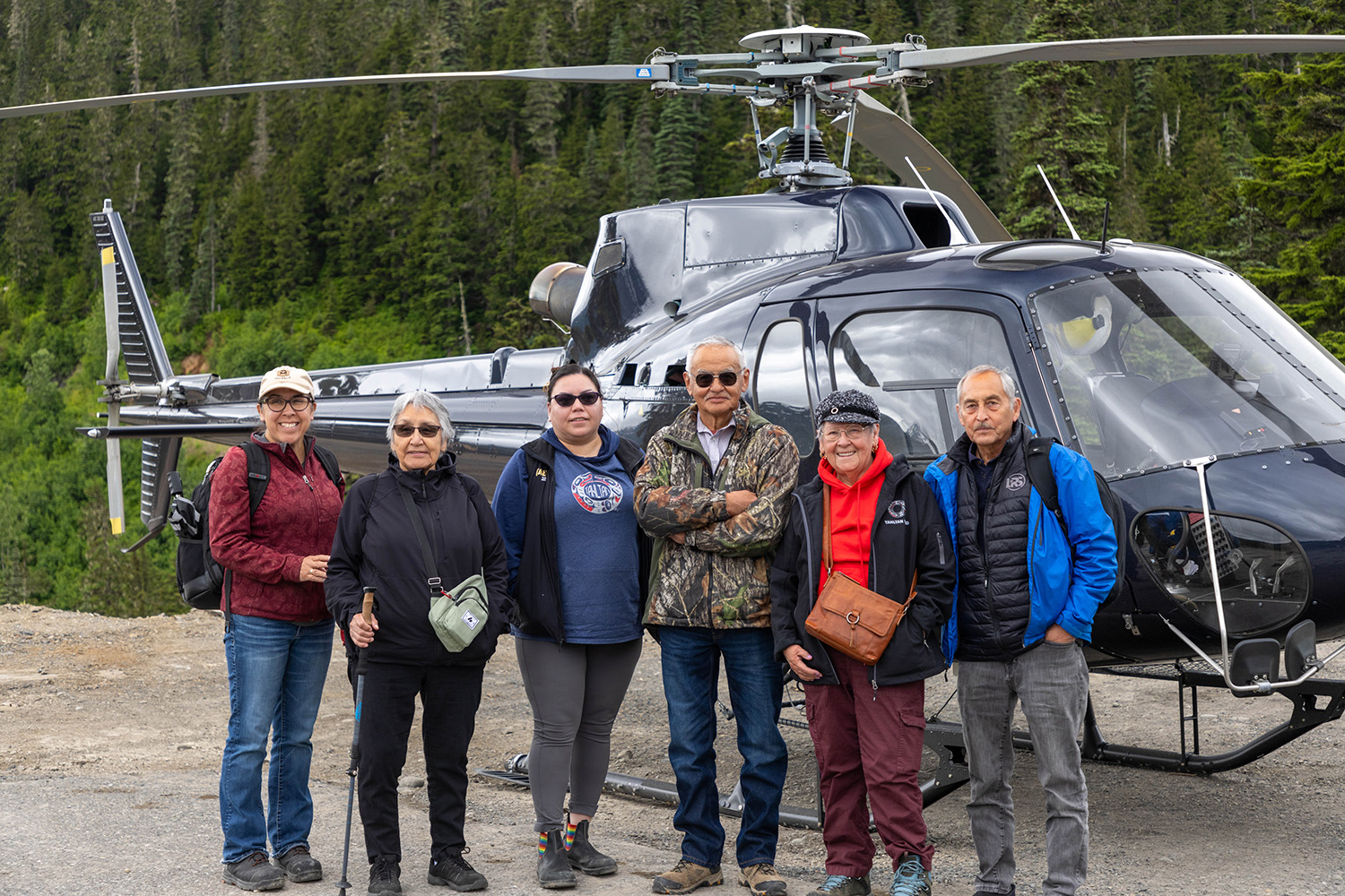 Group Of People Standing In Front Of A Helicopter