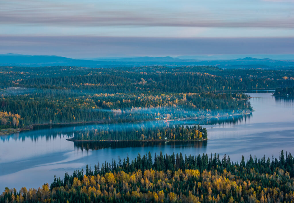 A Hazy Island In Summit Lake Covered In Fall Colors. Shot At Dusk From The Top Of Teapot Mountain Prince George British Columbia Canada
